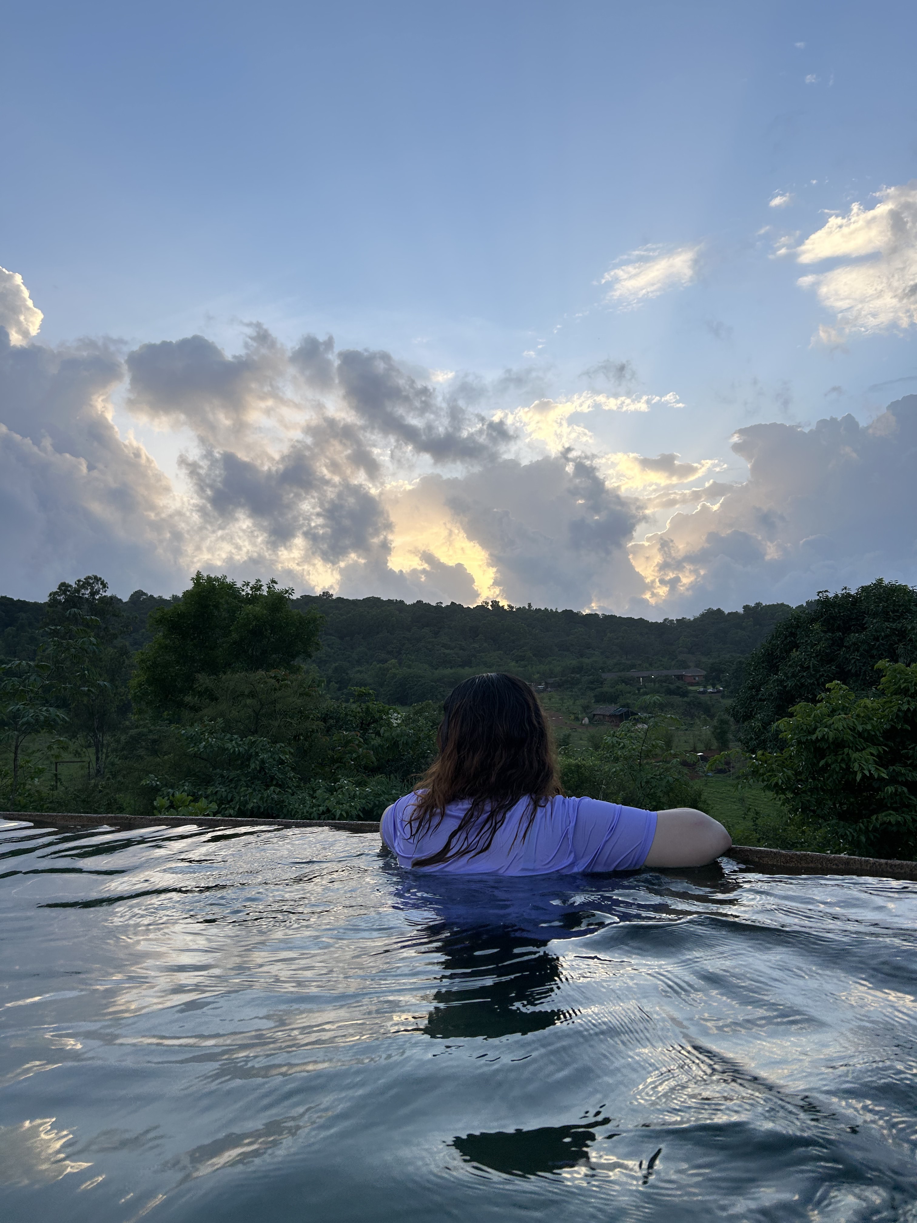 Looking out from an infinity pool at sunset